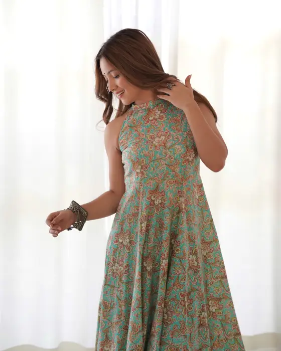 BLUE FLORALI FLARED KURTA .IT HAS A CLOSE NECK WITH BACK ZIP THIS IS SLEEVLESS DRESS PAIRED WITH AFGHANI SALWAR 